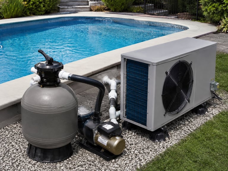 Pool equipment setup including sand filter, pump, and heat pump unit next to an in-ground swimming pool